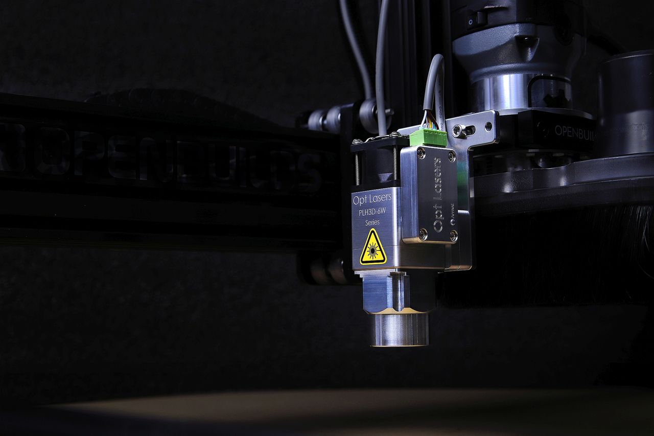 Detailed view of an Opt Lasers engraving machine in operation, showcasing precision technology.